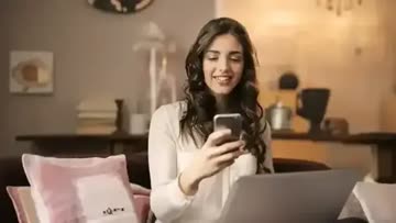 woman using a phone to control the lighting in her home