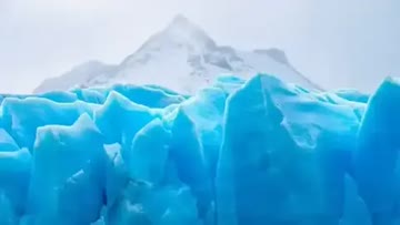 large ice field with distant mountain covered in snow