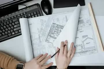 engineer working on residential designs with a pencil and ruler